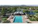 Aerial view of the community pool and recreation area featuring shade, lounges, and lake views at 4073 E Stable Ct, Gilbert, AZ 85297