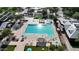 Aerial view of the community pool and lounging area featuring shade, umbrellas, and mature landscaping at 4073 E Stable Ct, Gilbert, AZ 85297