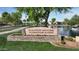 Community entrance sign for Ranch House Clubhouse & Park next to a body of water and walking trail at 4073 E Stable Ct, Gilbert, AZ 85297