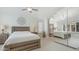 Comfortable main bedroom with a ceiling fan, closet with mirror doors, and neutral walls at 4073 E Stable Ct, Gilbert, AZ 85297