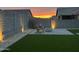 A backyard features adirondack chairs, a fire pit, and artificial turf at 4283 W Nora Dr, San Tan Valley, AZ 85144