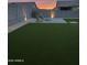 Backyard includes a brick patio with adirondack chairs, a concrete fire pit, and artificial turf at 4283 W Nora Dr, San Tan Valley, AZ 85144