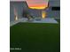 A backyard features adirondack chairs, a fire pit, and artificial turf at 4283 W Nora Dr, San Tan Valley, AZ 85144