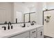 Bright bathroom featuring a double sink vanity, black hardware, large mirror and a glass enclosed shower at 4283 W Nora Dr, San Tan Valley, AZ 85144