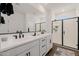 Bright bathroom with double sinks, a walk-in shower, and modern fixtures at 4283 W Nora Dr, San Tan Valley, AZ 85144