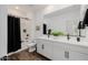 Modern bathroom with dual sinks, white cabinets, and black fixtures at 4283 W Nora Dr, San Tan Valley, AZ 85144