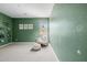 Large green-walled bedroom with view to the window and rocking chair at 4283 W Nora Dr, San Tan Valley, AZ 85144