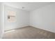 Bare, carpeted bedroom with white walls, a window and several electrical outlets at 4283 W Nora Dr, San Tan Valley, AZ 85144