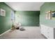 Spacious green-walled bedroom with a large window and modern furniture at 4283 W Nora Dr, San Tan Valley, AZ 85144
