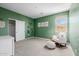 Large green-walled bedroom with view to the closet, window and rocking chair at 4283 W Nora Dr, San Tan Valley, AZ 85144