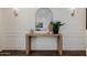 Close-up view of entryway console table featuring a round mirror and decor at 4283 W Nora Dr, San Tan Valley, AZ 85144