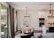 Bright dining area with modern light fixture, neutral decor, and access to the backyard at 4283 W Nora Dr, San Tan Valley, AZ 85144