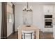 Dining area with a modern chandelier, seating for six, and natural light at 4283 W Nora Dr, San Tan Valley, AZ 85144