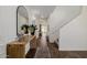 Welcoming entryway featuring a console table, decorative mirror, and hardwood floors at 4283 W Nora Dr, San Tan Valley, AZ 85144