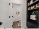 Stylish entryway with built-in storage, hooks, and convenient half bathroom at 4283 W Nora Dr, San Tan Valley, AZ 85144