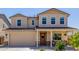 Charming two-story home featuring a welcoming front porch and a two car garage at 4283 W Nora Dr, San Tan Valley, AZ 85144