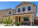 Inviting two-story home featuring a covered porch, desert landscaping, and a neutral color scheme at 4283 W Nora Dr, San Tan Valley, AZ 85144