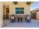 Relaxing front porch featuring neutral decor, hanging flower baskets, and stone accents at 4283 W Nora Dr, San Tan Valley, AZ 85144