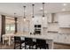 Modern kitchen features a large island, stainless steel appliances, and stylish light fixtures at 4283 W Nora Dr, San Tan Valley, AZ 85144