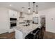 Bright kitchen featuring a large island with seating, stainless steel appliances, and a pantry at 4283 W Nora Dr, San Tan Valley, AZ 85144