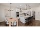 Modern kitchen and dining area features a large island, stainless steel appliances, and neutral decor at 4283 W Nora Dr, San Tan Valley, AZ 85144