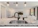 Modern kitchen featuring granite counters, a black faucet, and view of the living room at 4283 W Nora Dr, San Tan Valley, AZ 85144