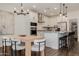 Modern kitchen features an island with bar stool seating, stylish light fixtures, and dining area at 4283 W Nora Dr, San Tan Valley, AZ 85144