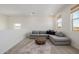 Bright living area with a gray sectional couch and neutral decor at 4283 W Nora Dr, San Tan Valley, AZ 85144