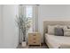 Comfortable bedroom with a nightstand, decorative tree, and soft lighting at 4283 W Nora Dr, San Tan Valley, AZ 85144