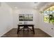 Bright and airy office space with wood-look floors and a large window at 4283 W Nora Dr, San Tan Valley, AZ 85144