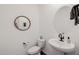 Chic powder room featuring pedestal sink, round mirrors, and white walls at 4283 W Nora Dr, San Tan Valley, AZ 85144