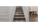 Carpeted staircase with white walls and handrail and a dining area nearby at 4283 W Nora Dr, San Tan Valley, AZ 85144
