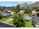 Aerial view of a home with lush green lawn and mature trees against a mountain backdrop at 4510 E Calle Tuberia --, Phoenix, AZ 85018