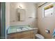 Retro bathroom featuring a vanity with a sink, a mirror, and vintage turquoise tile at 4510 E Calle Tuberia --, Phoenix, AZ 85018