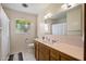 A functional bathroom with a large mirror, wood vanity, and a combination shower and tub at 4510 E Calle Tuberia --, Phoenix, AZ 85018
