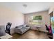 Bright living room with a large window, a gray sofa, and neutral walls at 4510 E Calle Tuberia --, Phoenix, AZ 85018
