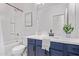 Bright bathroom features a shower and blue vanity at 45722 W Sky Ln, Maricopa, AZ 85139
