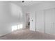 This bedroom offers neutral carpet and a bathroom view at 45722 W Sky Ln, Maricopa, AZ 85139