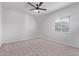 An empty, bright bedroom featuring plush carpet and a ceiling fan at 45722 W Sky Ln, Maricopa, AZ 85139