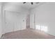 This bedroom offers neutral carpet, closet, and ceiling fan at 45722 W Sky Ln, Maricopa, AZ 85139