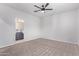 Spacious bedroom with a ceiling fan and connecting bathroom with a double sink at 45722 W Sky Ln, Maricopa, AZ 85139