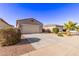 Inviting one-story home with desert landscaping, large driveway, and covered entry, offering curb appeal at 45722 W Sky Ln, Maricopa, AZ 85139