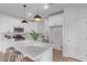 Bright kitchen featuring white cabinetry, stainless steel appliances, and a center island with pendant lighting at 45722 W Sky Ln, Maricopa, AZ 85139