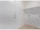 The spacious laundry room has hookups and a shelf at 45722 W Sky Ln, Maricopa, AZ 85139