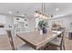 Open-concept living space featuring dining area, kitchen with bar seating and modern lighting fixtures at 45722 W Sky Ln, Maricopa, AZ 85139
