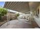 Private backyard patio with stone wall, covered structure, and comfortable lounge seating at 5111 N 83Rd St, Scottsdale, AZ 85250