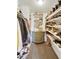 Custom closet with shelving for shoes, hanging rods for clothes, and a decorative cabinet at 5111 N 83Rd St, Scottsdale, AZ 85250