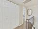 Neutral hallway featuring a closet, round mirror, and entrance to a bedroom space at 5111 N 83Rd St, Scottsdale, AZ 85250