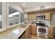 Well-lit kitchen with granite countertops, stainless steel appliances, and ample cabinet space for storage at 5111 N 83Rd St, Scottsdale, AZ 85250
