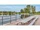 Scenic lake view featuring picnic tables and mature trees with mountain views in the distance at 5111 N 83Rd St, Scottsdale, AZ 85250
